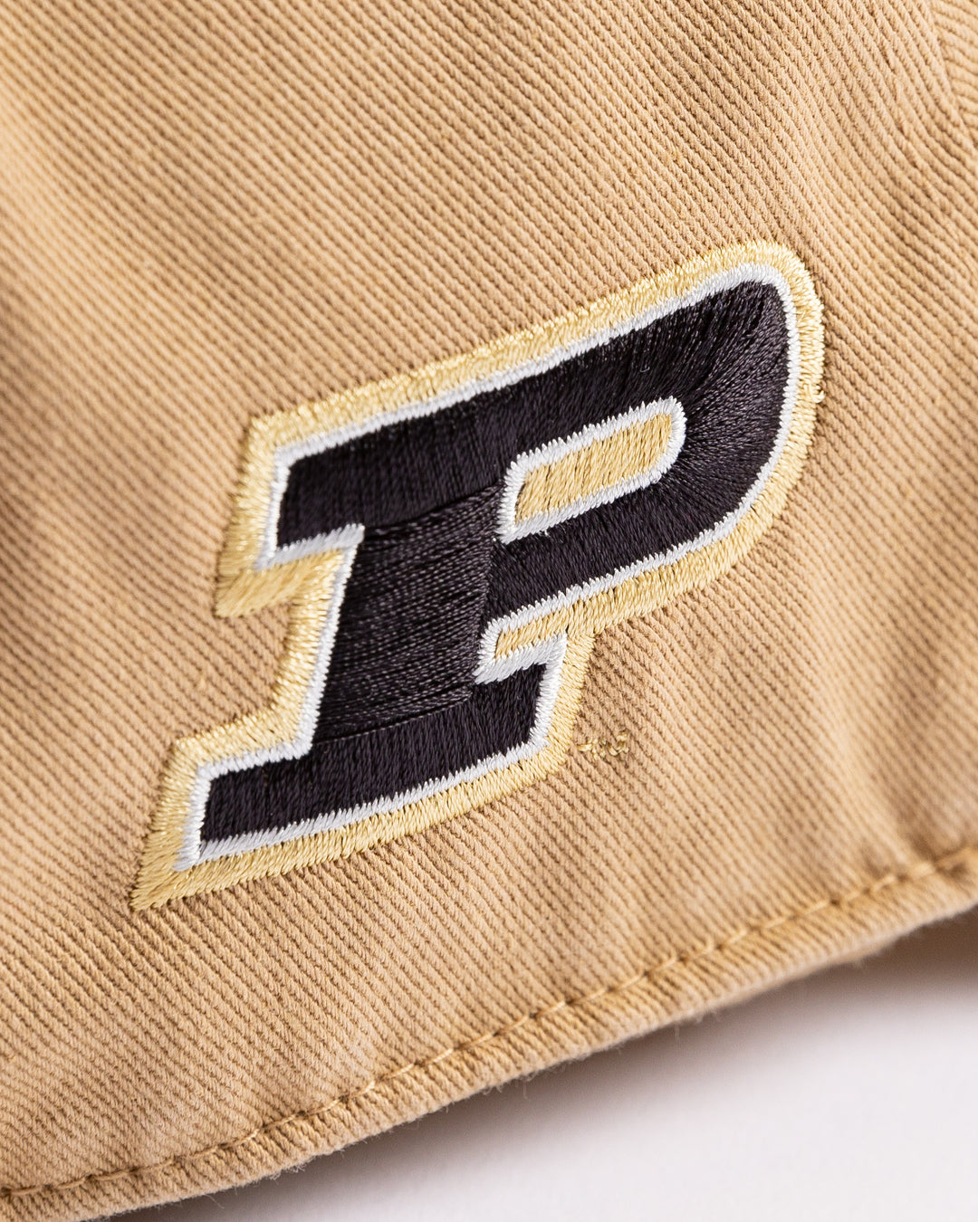 khaki '47 brand adjustable cap with Chicago Blackhawks four feathers logo embroidered on front and Purdue University logo embroidered on right side - Purdue University detail lay flat