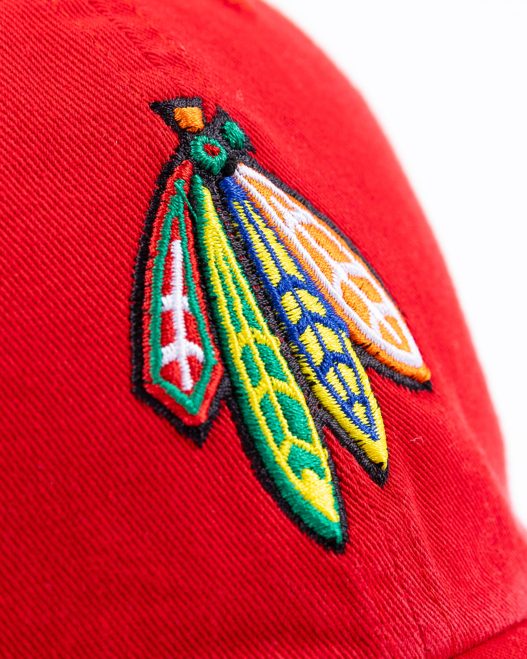 red '47 brand adjustable cap with Chicago Blackhawks four feathers logo on front and University of Wisconsin Madison logo on right side - front detail  lay flat