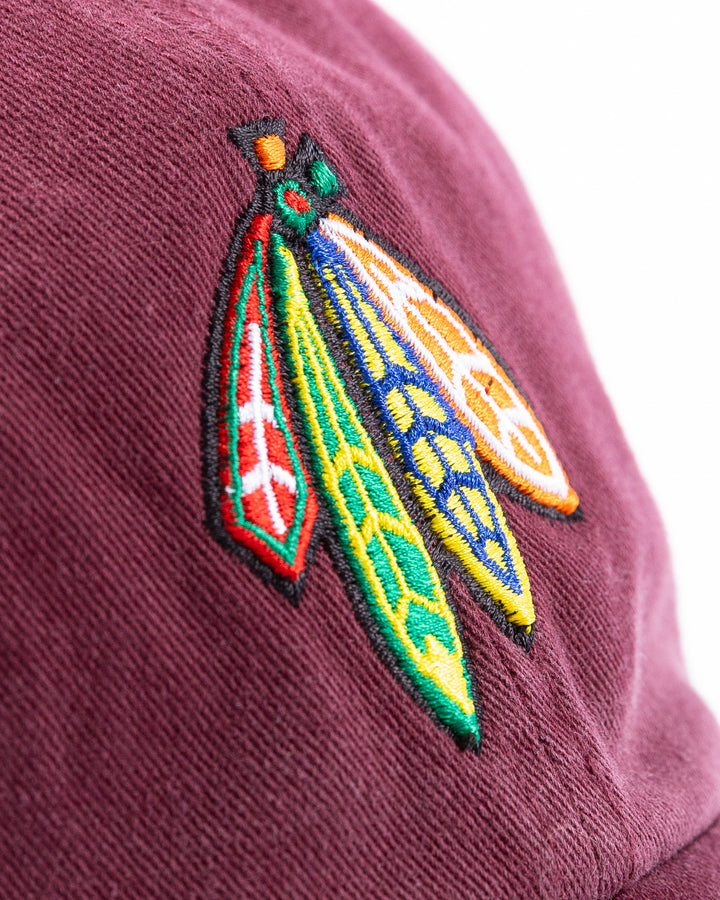 maroon '47 brand adjustable hat with Chicago Blackhawks four feathers logo embroidered on front and Loyola University Chicago logo embroidered on right side - four feathers detail lay flat