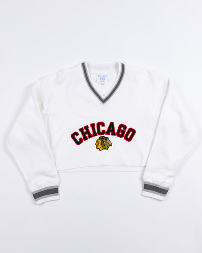 white Champion ladies cropped v neck sweatshirt with embroidered Chicago and primary logo - front lay flat