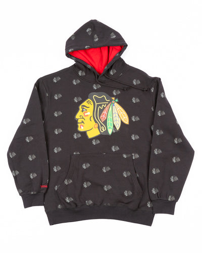black Mitchell & Ness hoodie with all over Chicago Blackhawks primary logo all over printed with primary logo printed on center chest - front lay flat
