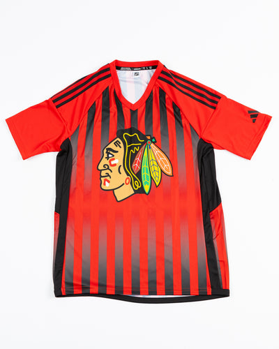 red adidas soccer inspired top with Chicago Blackhawks primary logo printed across the chest - front lay flat