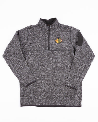 black Antigua quarter zip with Chicago Blackhawks primary logo embroidered on left chest - front lay flat