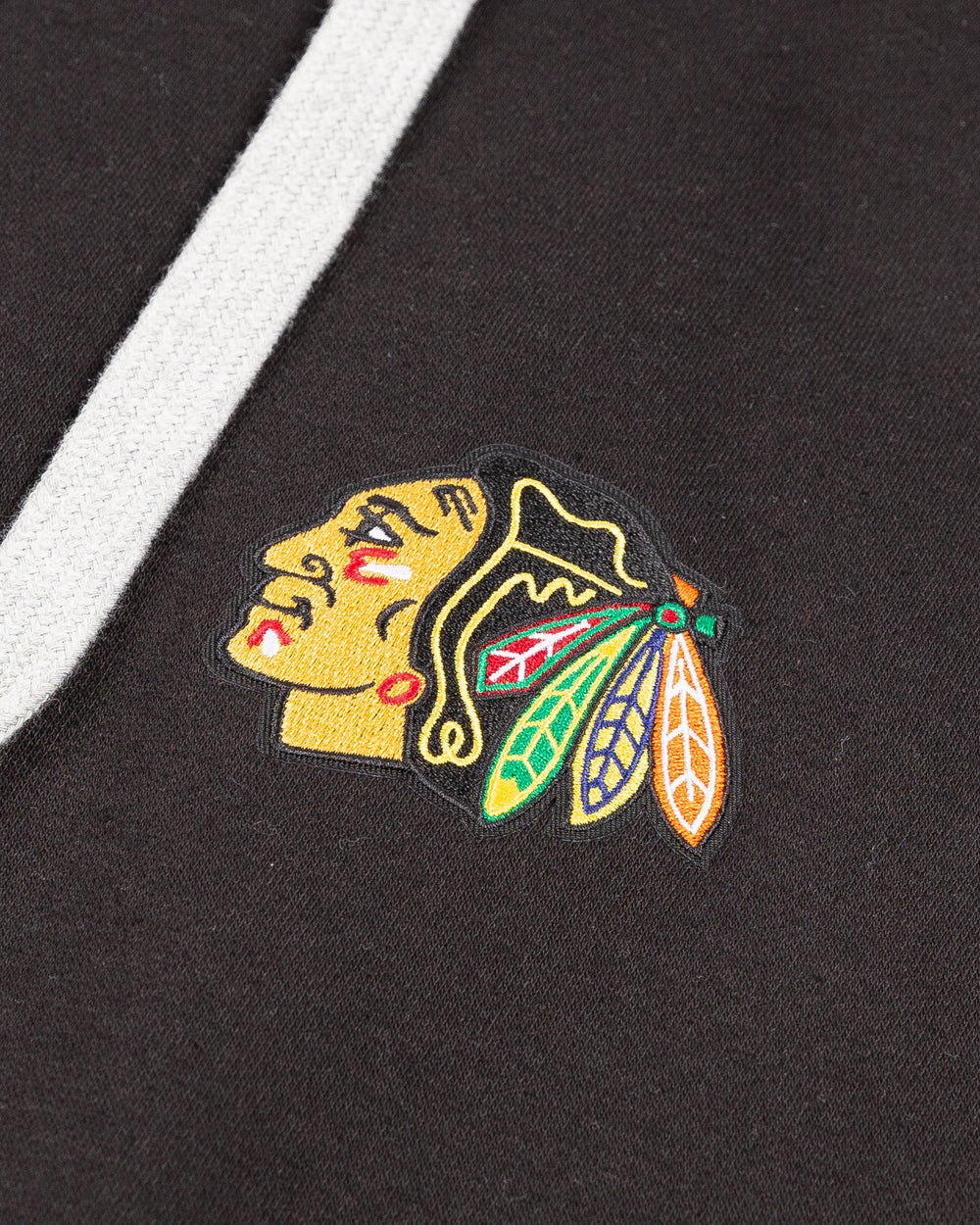 black big & tall Antigua hoodie with embroidered Chicago Blackhawks primary logo on left chest - detail lay flat