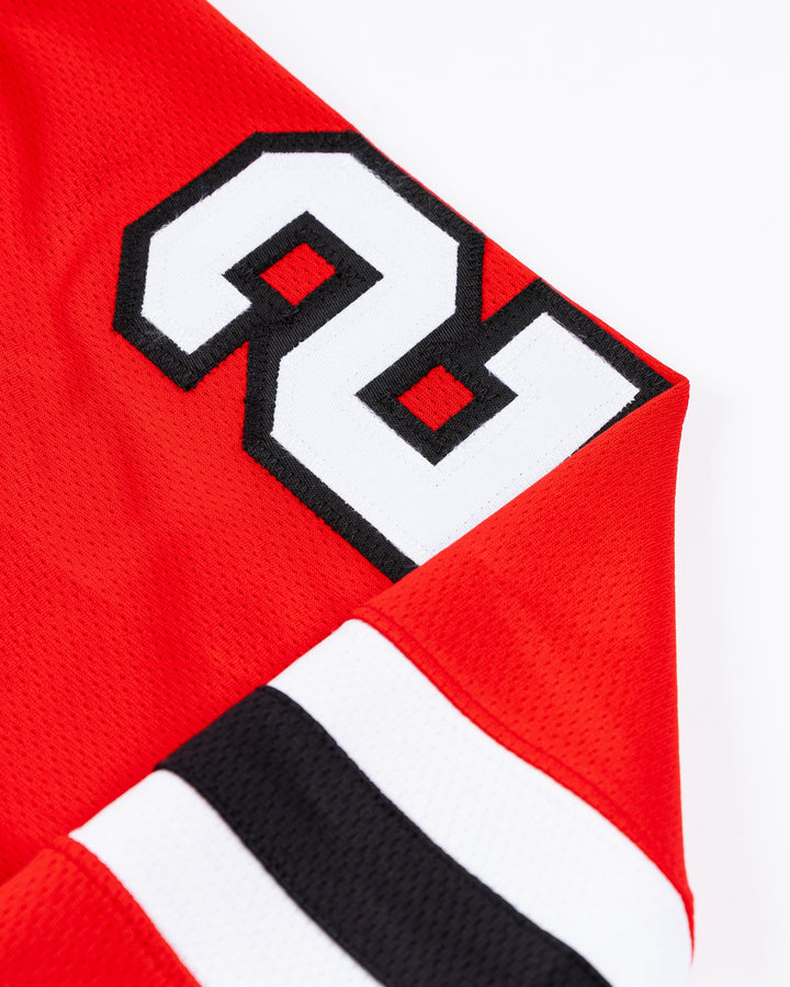 red Fanatics Chicago Blackhawks jersey with Lukas Reichel stitched name and number - shoulder detail lay flat