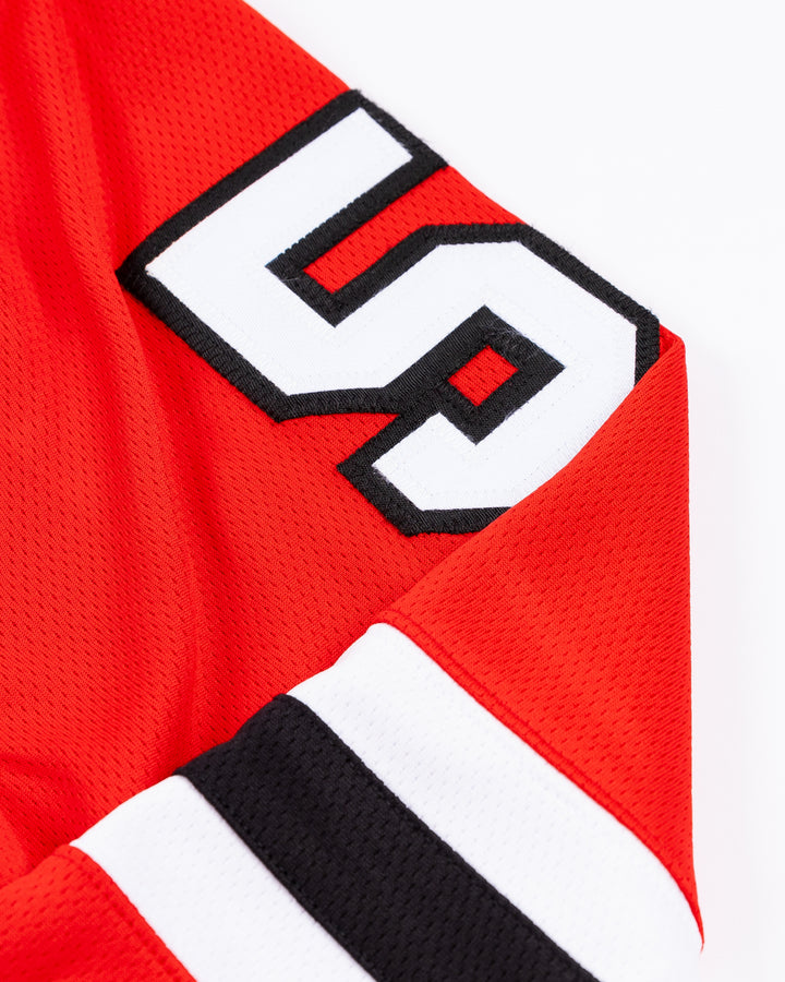 red Fanatics Chicago Blackhawks jersey with stitched Kevin Korchinski name and number - shoulder detail lay flat