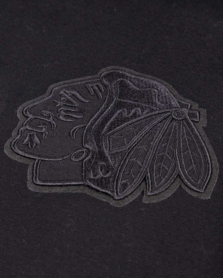 black Pro Standard hoodie with tonal Chicago Blackhawks patches throughout - front patch detail lay flat