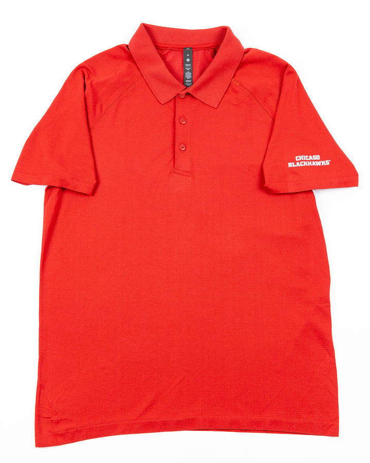 red lululemon polo with Chicago Blackhawks wordmark on left shoulder - front lay flat