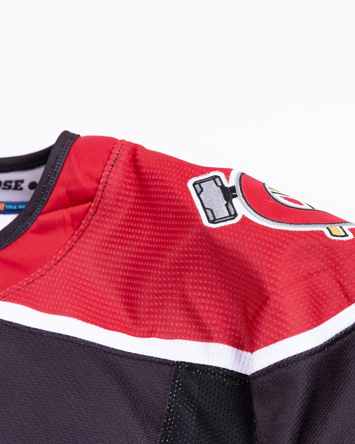 black Chicago Steel hockey jersey - shoulder detail lay flat