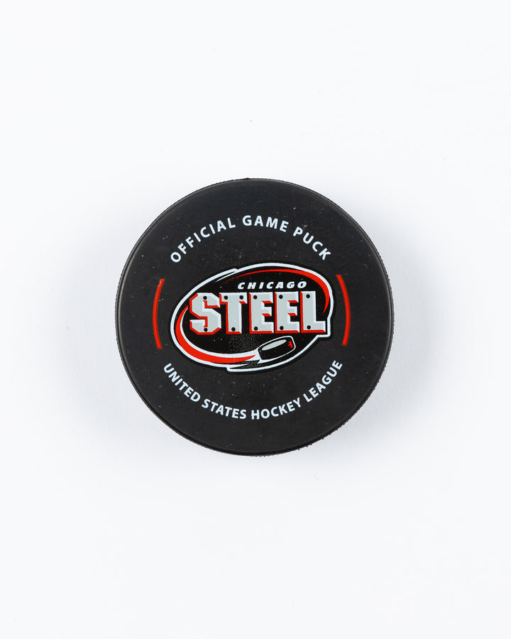 official 23-24 game puck of the Chicago Steel - front lay flat