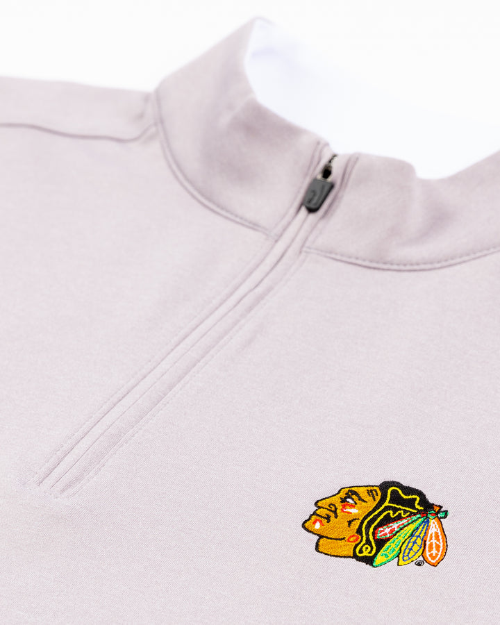 light grey johnnie-o quarter zip with embroidered Chicago Blackhawks primary logo on left chest - detail lay flat