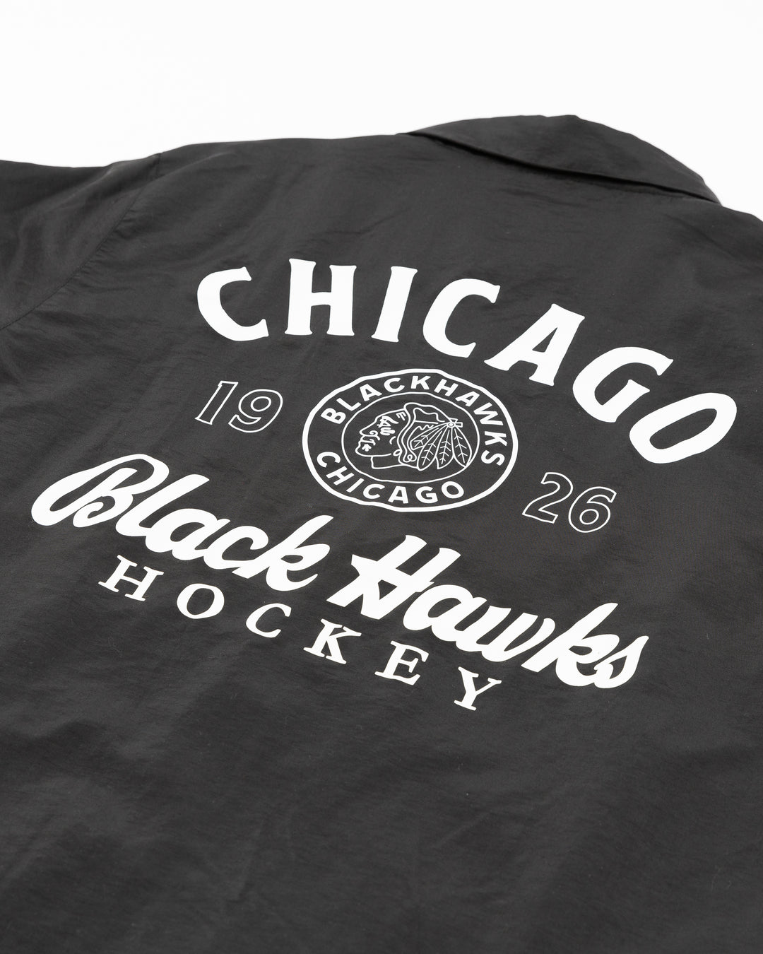 black American Needle coaches jacket with vintage Chicago Blackhawks logo on front left chest and graphic on back - back detail lay flat