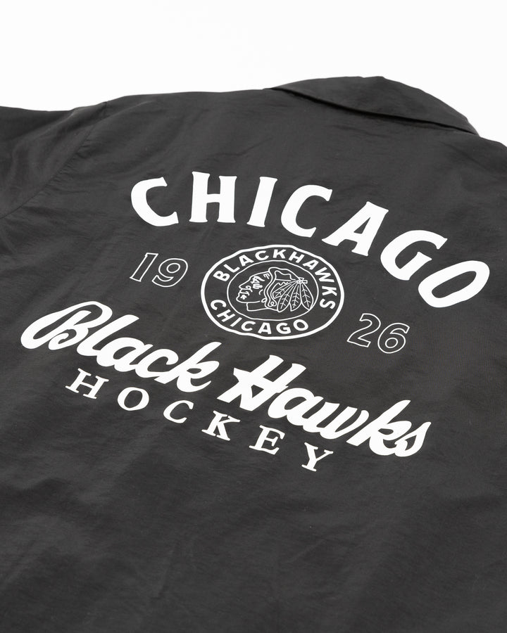 black American Needle coaches jacket with vintage Chicago Blackhawks logo on front left chest and graphic on back - back detail lay flat