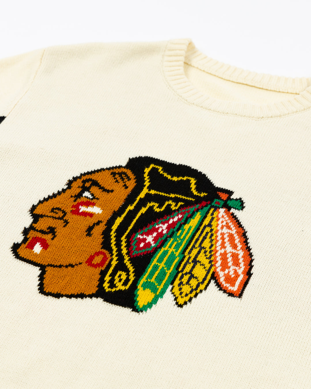 knitted ivory American Needle crewneck sweater with Chicago Blackhawks primary logo on front and stripe detailing on sleeves - front detail lay flat