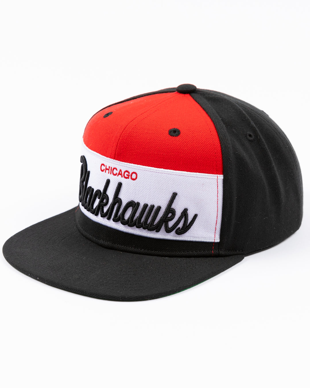 black white and red Mitchell & Ness snapback cap with Chicago Blackhawks wordmark on front and primary logo on right side - left angle lay flat