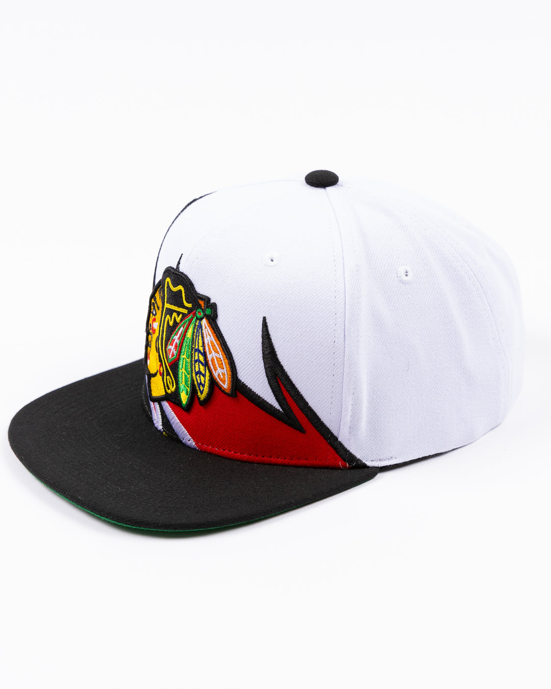 white and black Mitchell & Ness snapback cap with embroidered Chicago Blackhawks primary logo on wave design - left angle lay flat