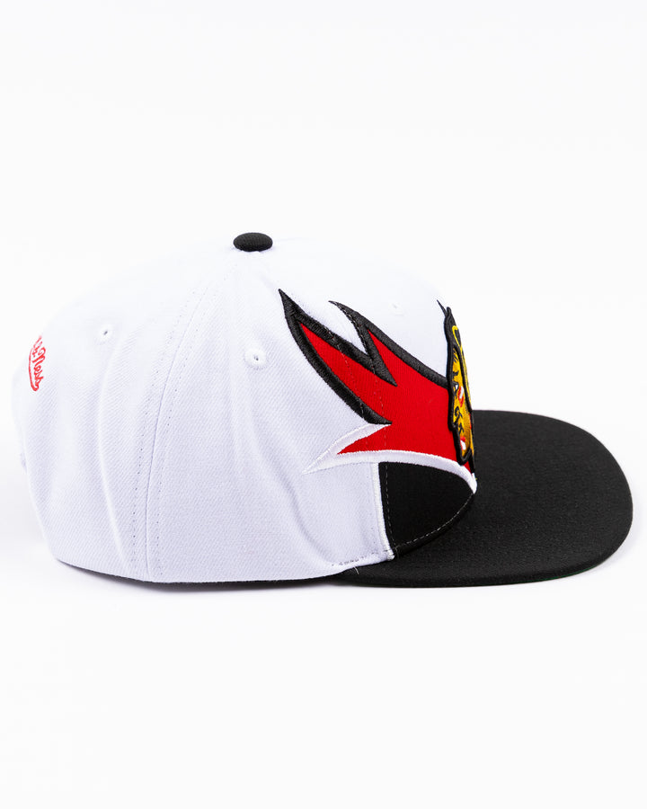 white and black Mitchell & Ness snapback cap with embroidered Chicago Blackhawks primary logo on wave design - right side  lay flat