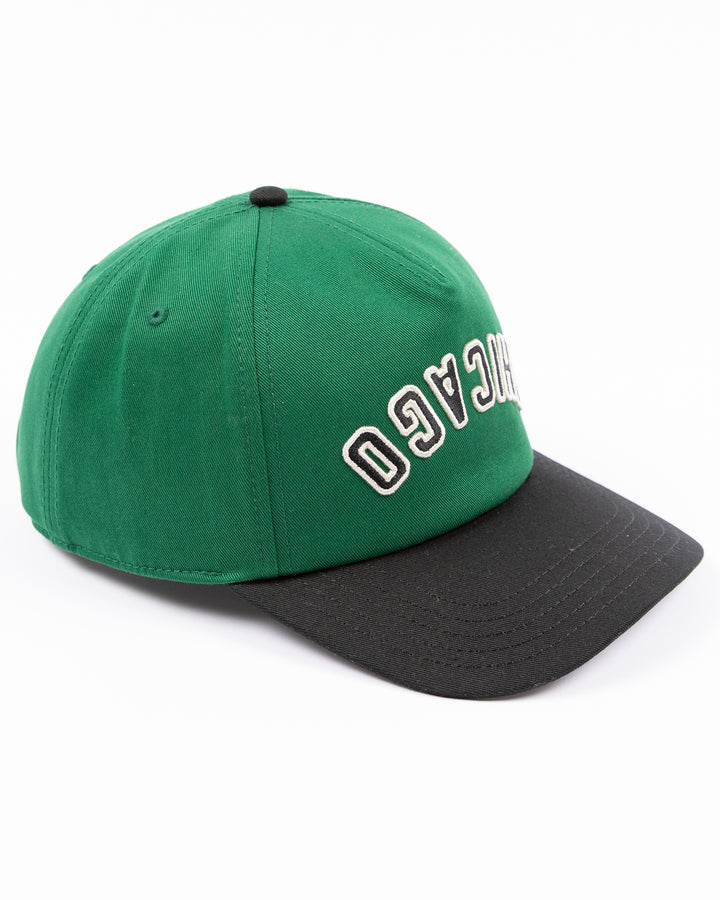 American Needle Roscoe snapback cap in green and black with upside down Chicago wordmark on front and Chicago Blackhawks primary logo on left side - right angle lay flat