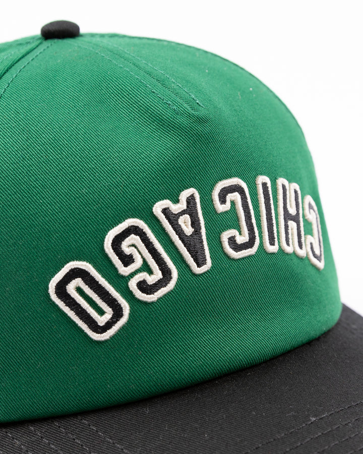 American Needle Roscoe snapback cap in green and black with upside down Chicago wordmark on front and Chicago Blackhawks primary logo on left side - front detail lay flat