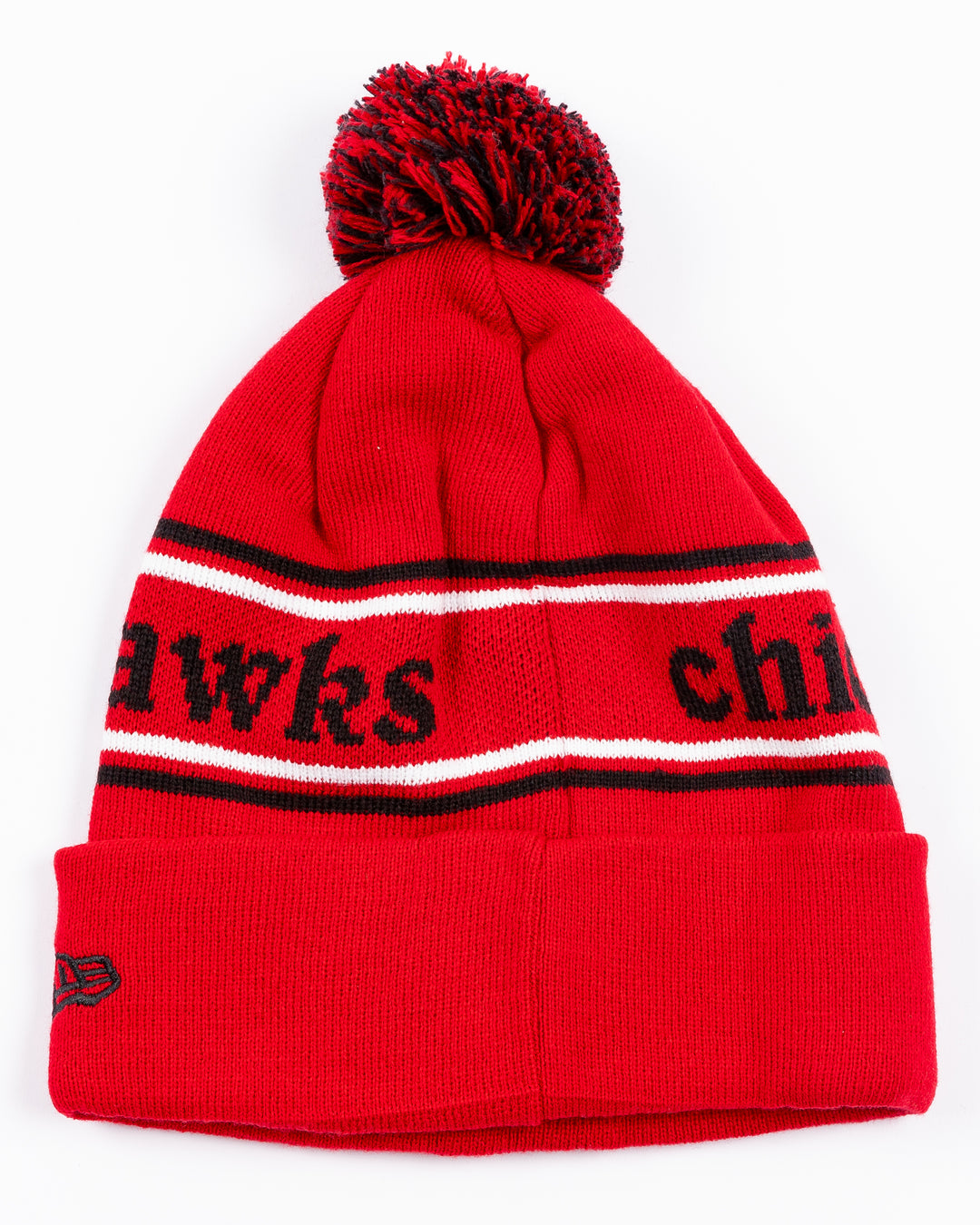 red New Era beanie with two tone pom and Chicago Blackhawks wordmark across front and embroidered primary logo on front cuff - back lay flat