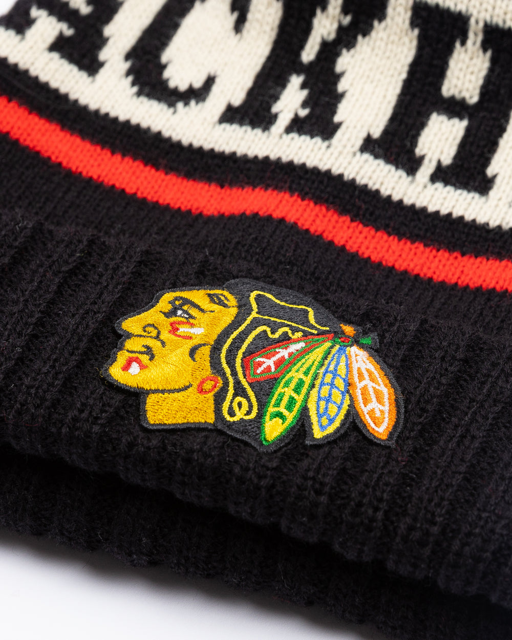 American Needle black knit pom hat with Chicago Blackhawks wordmark on front and embroidered primary logo on front cuff - detail  lay flat