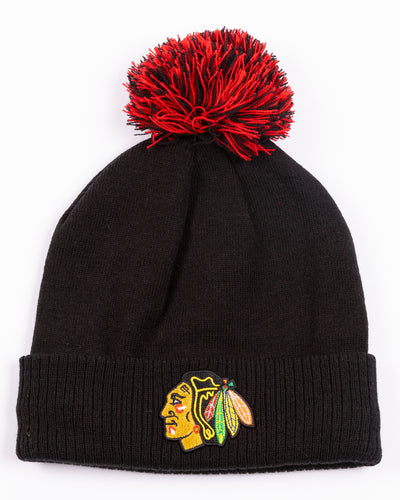 black adidas knit beanie with red and black pom and embroidered Chicago Blackhawks primary logo on front cuff - front lay flat