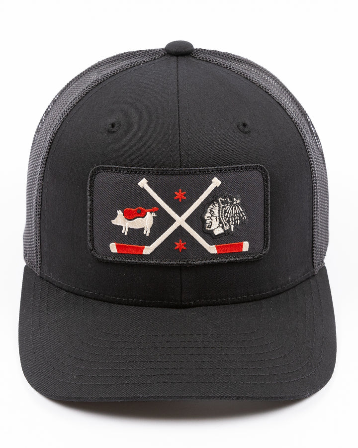 black trucker hat with patch of Windy City Smokeout logo and Chicago Blackhawks primary logo on front - front lay flat