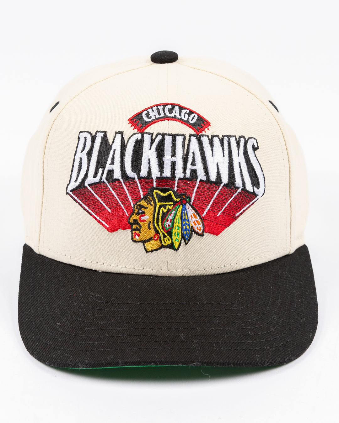 youth cream and black Mitchell & Ness snapback cap with Chicago Blackhawks wordmark and primary logo on front - front lay flat