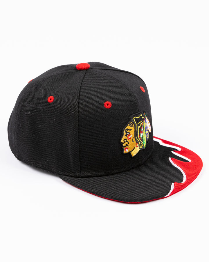 youth black MItchell & Ness snapback cap with Chicago Blackhawks primary logo on front and tide design embroidered on brim and left side - right angle lay flat