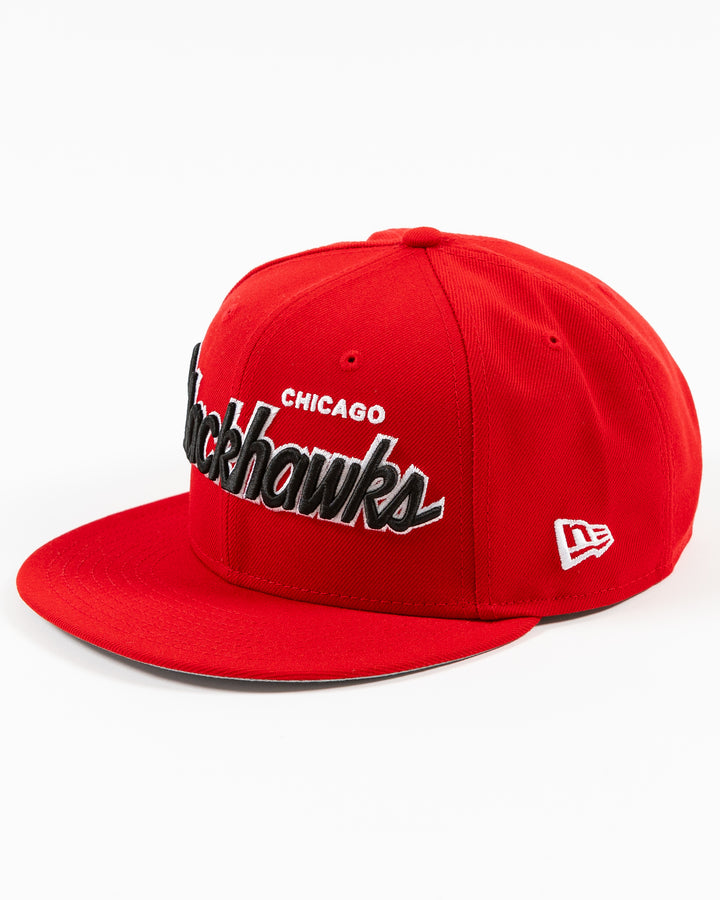 red New Era 9FIFTY snapback cap with Chicago Blackhawks wordmark on front and primary logo on right side - left angle lay flat