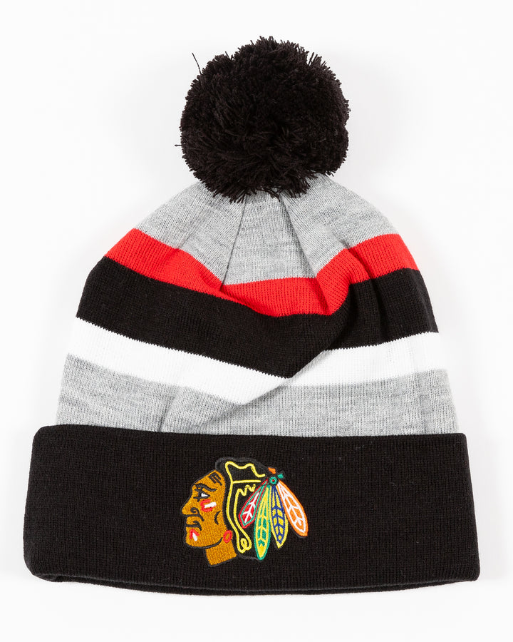 striped CCM knit hat with pom with Chicago Blackhawks primary logo embroidered on front cuff - front lay flat