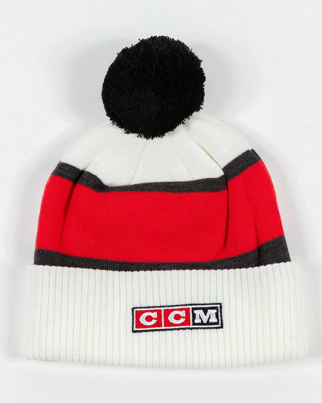 white CCM knit hat with pom with Chicago wordmark on front and Chicago Blackhawks primary logo embroidered on front cuff - back lay flat