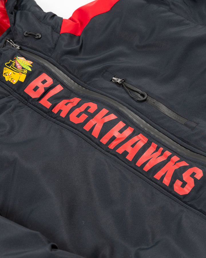 black full zip Colosseum jacket with hood with Chicago Blackhawks primary logo and wordmark at top of zipper detail - front detail lay flat