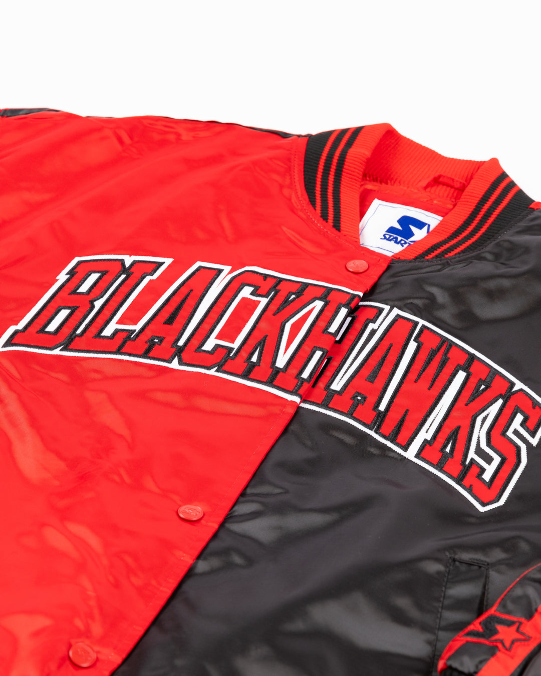 two tone red and black women's Starter jacket with Blackhawks wordmark on front and Chicago wordmark on back with Chicago Blackhawks primary logo - front detail lay flat