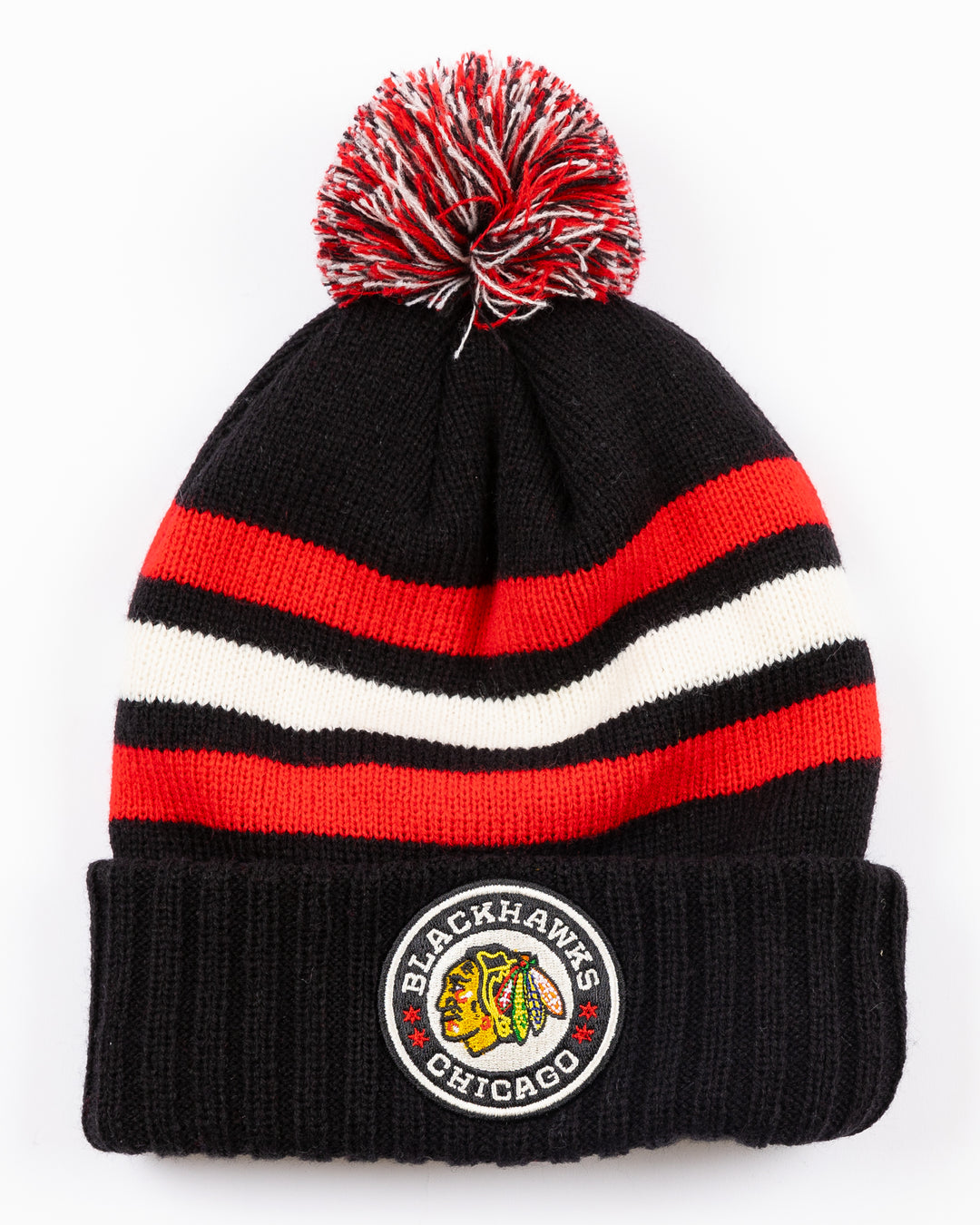 striped black white and red American Needle pom knit hat with multi color pom on top and Chicago Blackhawks and NHL Winter Classic patches embroidered on front and back - front lay flat