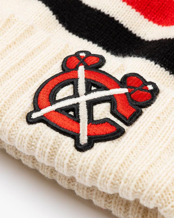 striped cream red and white American Needle knit pom hat with multicolor pom and Chicago Blackhawks secondary logo embroidered on front and NHL Winter Classic logo embroidered on back - front detail lay flat