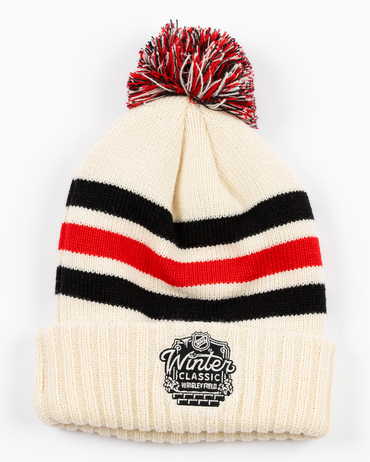 striped cream red and white American Needle knit pom hat with multicolor pom and Chicago Blackhawks secondary logo embroidered on front and NHL Winter Classic logo embroidered on back - back lay flat