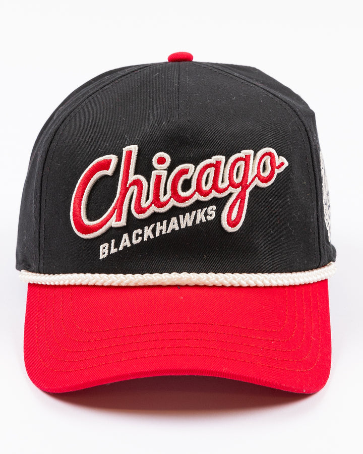 two tone black and red rope American Needle snapback cap with Chicago Blackhawks wodmark embroidered on front and Winter Classic logo embroidered on left side - front lay flat