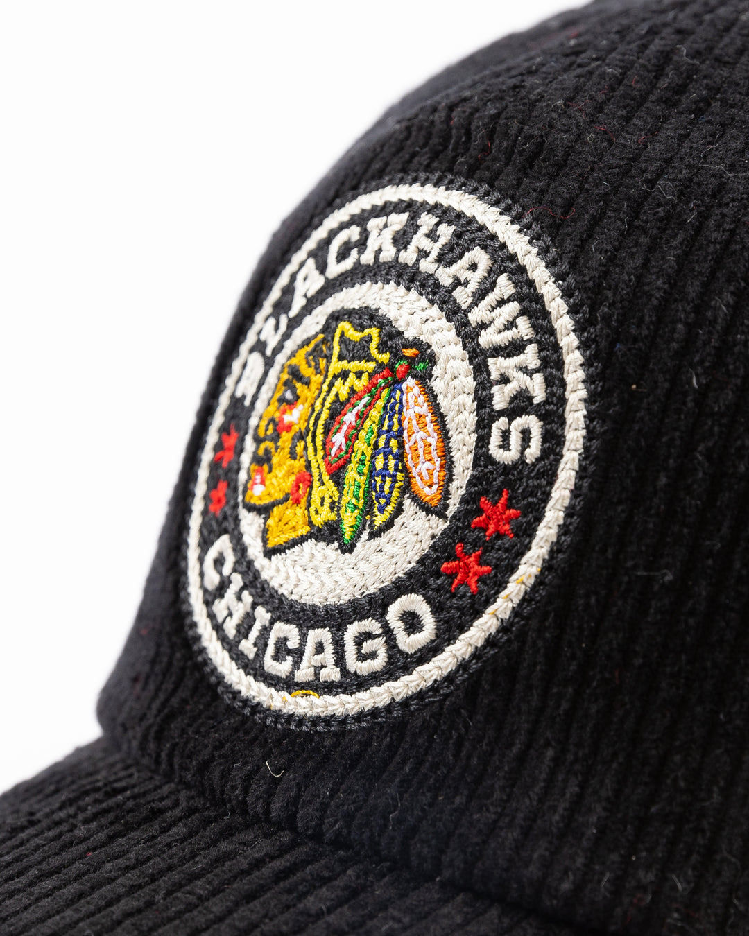 black corduroy American Needle snapback cap with Chicago Blackhawks Winter Classic logo on front and NHL Winter Classic logo on left side - front detail lay flat