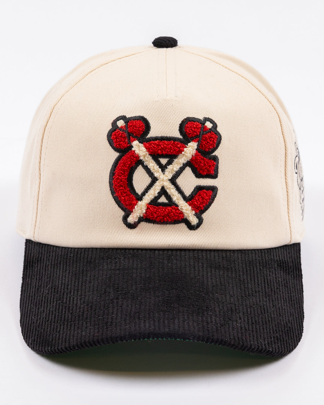 two tone ivory and black American Needle adjustable snapback hat with chenille Chicago Blackhawks secondary logo and Winter Classic logo embroidered on left side - front lay flat