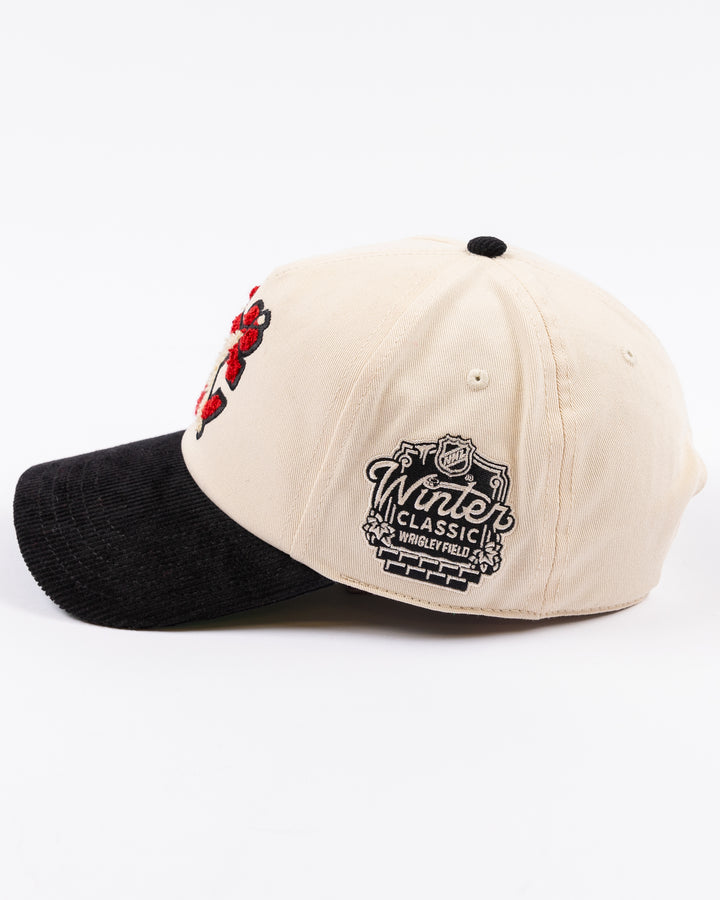 two tone ivory and black American Needle adjustable snapback hat with chenille Chicago Blackhawks secondary logo and Winter Classic logo embroidered on left side - left side lay flat