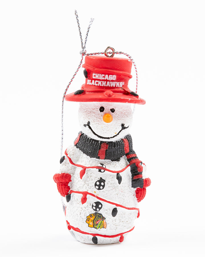 snowman ornament wearing top hat with Chicago Blackhawks wordmark and primary logo on bottom with string lights - front lay flat