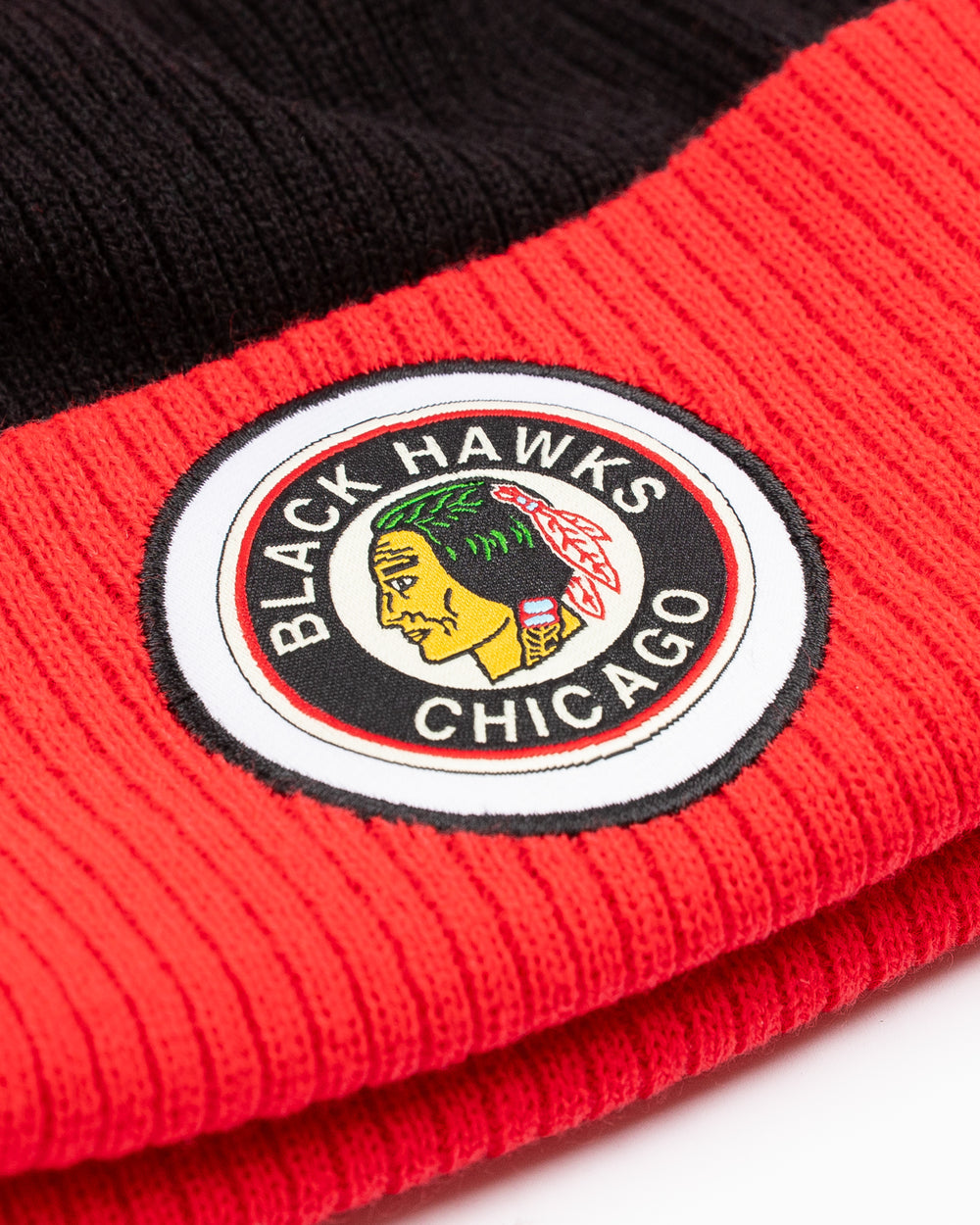 red, black and white CCM knit pom with red pom on top and vintage Chicago Blackhaks logo embroidered on front cuff - front detail lay flat