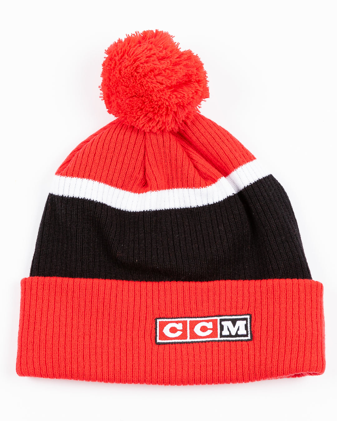 red, black and white CCM knit pom with red pom on top and vintage Chicago Blackhaks logo embroidered on front cuff - back lay flat