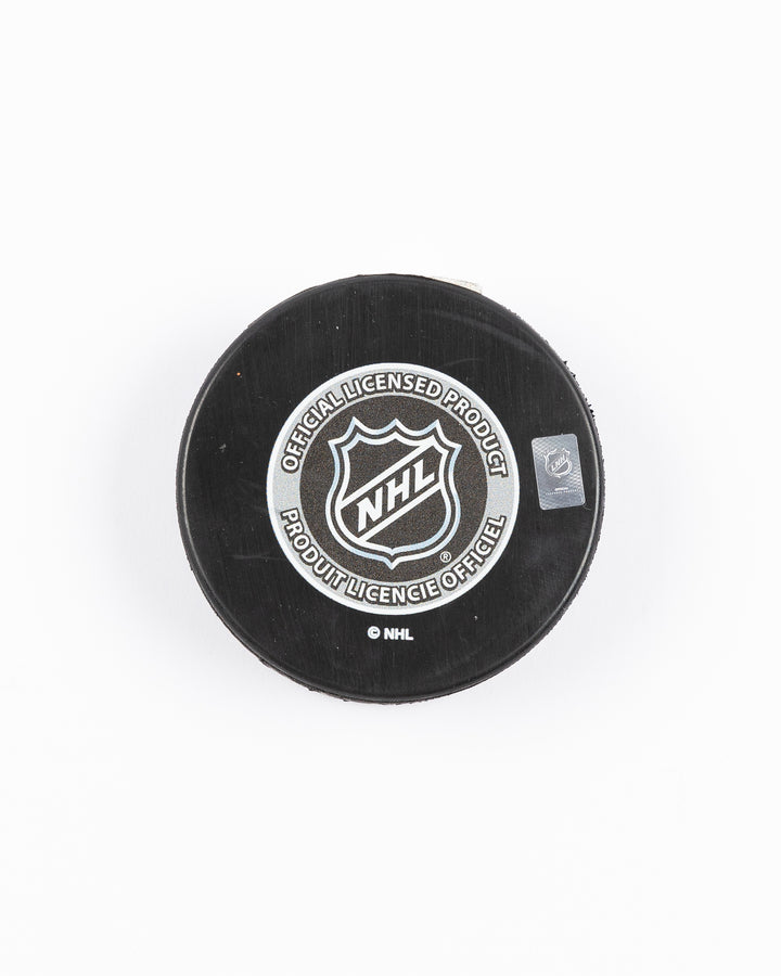 Mustang hockey puck with Winter Classic at Wrigley Field graphic on front against Chicago Blackhawks vs. St. Louis Blues - back lay flat