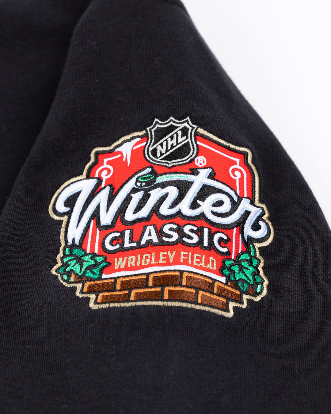 black Mitchell & Ness lace up crewneck with Chicago Blackhawks Winter Classic embroidered patches on front and shoulders - left shoulder detail lay flat