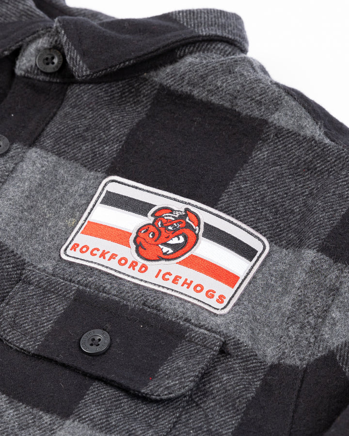 black and dark gray plaid button down flannel with Rockford IceHogs patch on left chest - front letail lay flat