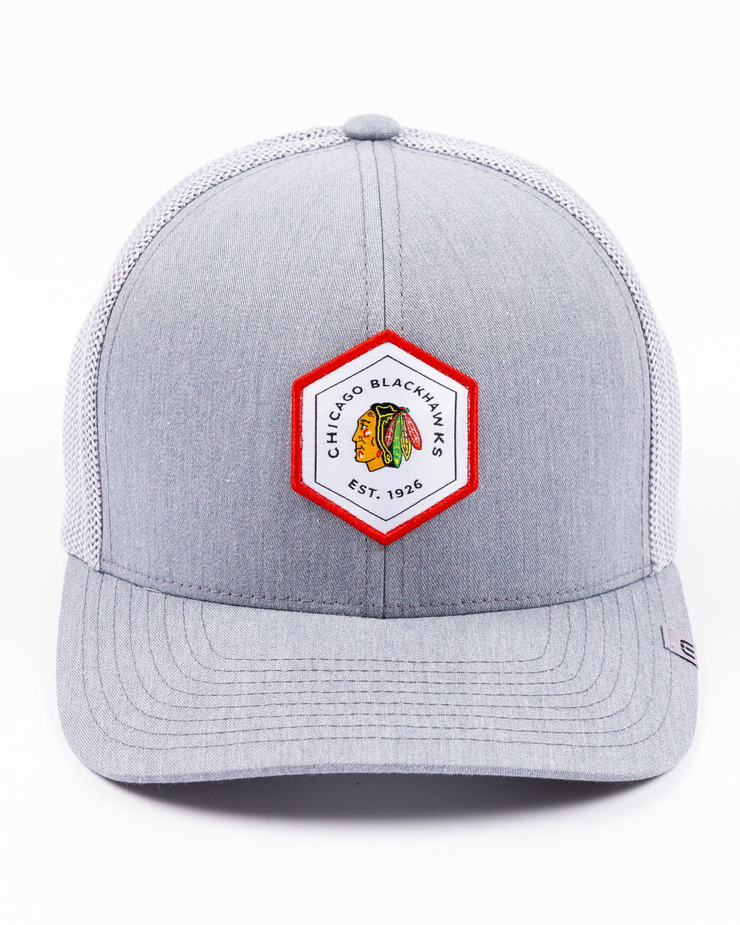 heather grey TravisMathew adjustable trucker cap with hexagon patch on front with Chicago Blackhawks primary logo and wordmark - front lay flat