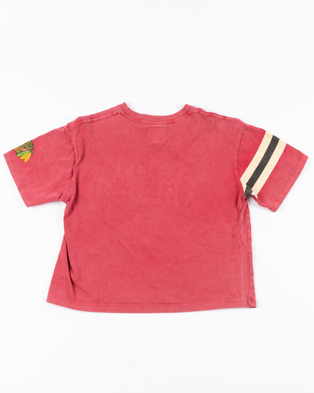 red boxy crop Alice & Wonder tee with Chicago wordmark across front and Chicago Blackhawks primary logo on left sleeve and jersey stripes on right sleeve - back lay flat