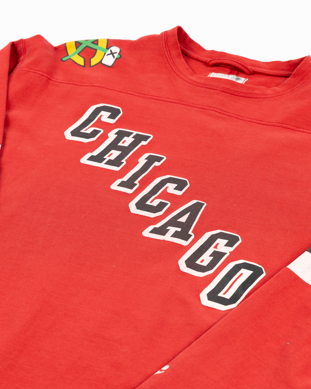 red Alice & Wonder long sleeve tee with diagonal Chicago wordmark and Chicago Blackhawks secondary and primary logo on shoulders and jersey-inspired stripes on sleeves - front detail lay flat